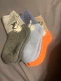 Kid items a Dinosaur, sock and Tee-Shirt