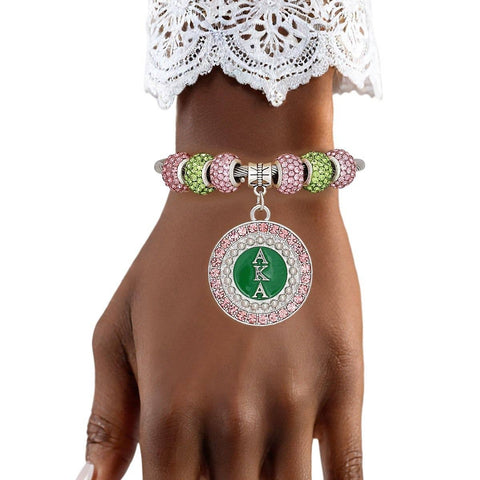 PinktownUSA - AKA Greek Merch Bead and Charm Cable Bracelet: Color: Pink and Green / Plating: Rhodium / Size: Adjustable
